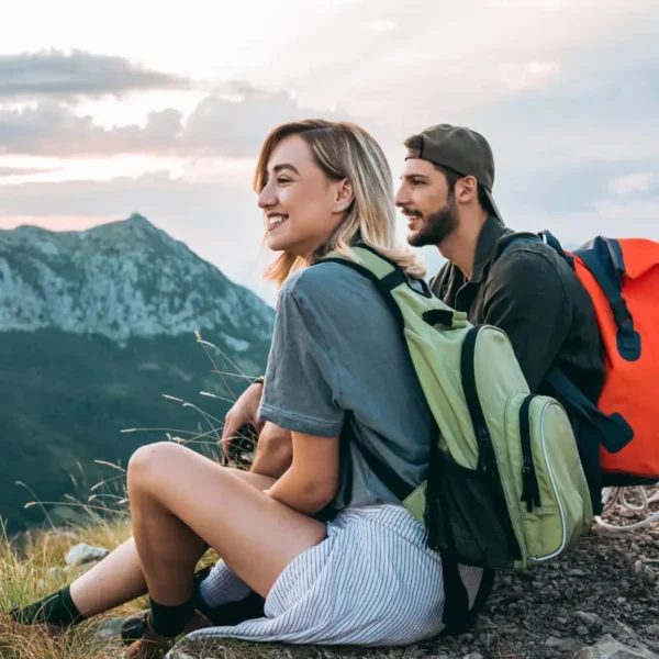 Couple on a mountain resting after hiking