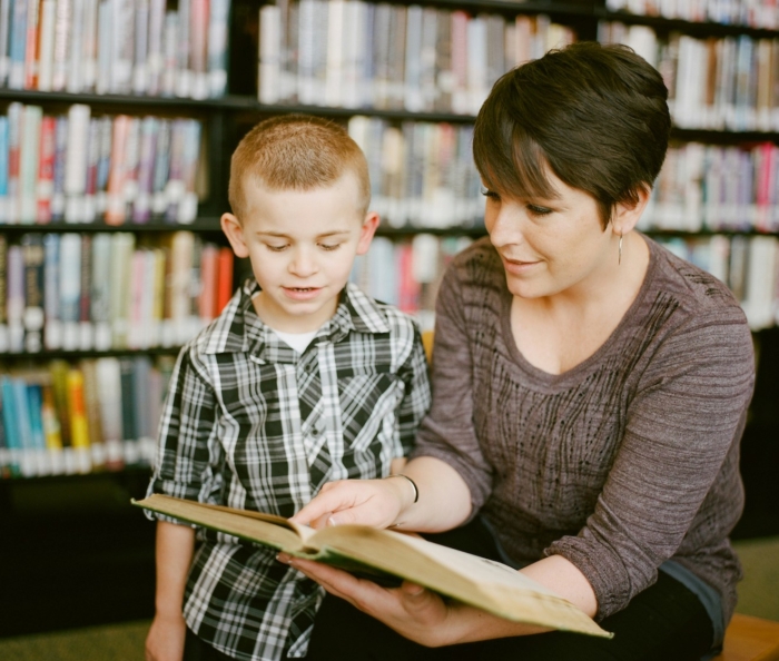 Woman reading with child - education